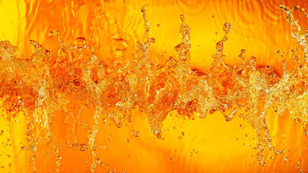 Liquid golden splash texture, abstract beverages background. Whisky, rum, cognac, tea or oil. - Photo, image