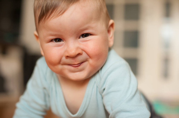 Portrait of cute happy baby boy looking at camera. Joy and happiness concept. Love and family emotion - Фото, изображение