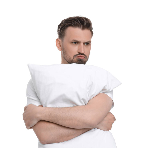Unhappy man with pillow on white background. Insomnia problem - Foto, Imagem
