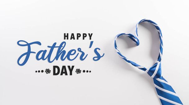 Happy Fathers Day background concept made from necktie with heart shape and the text on white background. - Photo, Image
