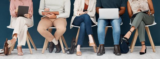 Technology, diversity with group of people and sitting together. Laptop, smartphone and tablet. Social networking or media, connectivity or streaming media and colleagues with tech sit on chair. - Photo, Image