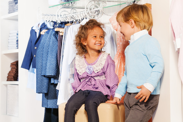 Girl and boy in clothes store - 写真・画像