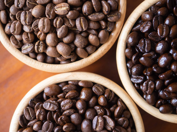 brown arabica coffee bean roast 3 level medium to dark different taste seed caffeine espresso drink food cafe beverage Chiang Rai, Thailand coffee on wooden table background top view selected focus - Photo, Image