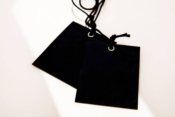neutral black label with lanyard on a white background - Photo, Image