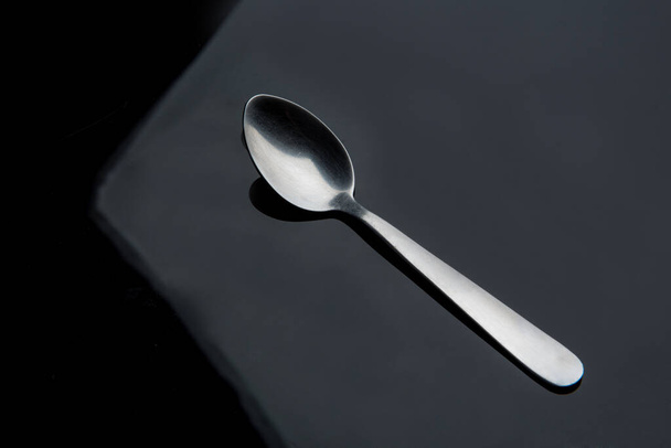 Silver spoon on a black background  - Foto, Imagem