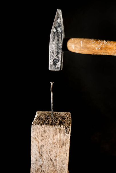 hammer hits a nail into a wooden plank - Photo, Image