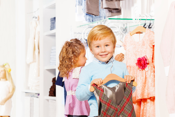 Girl and boy in clothes store - Valokuva, kuva