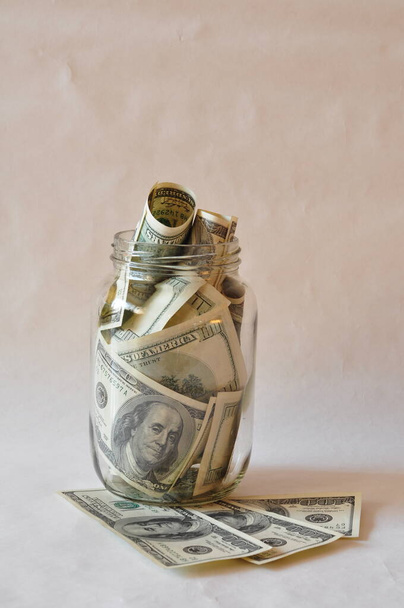 dollars in the glass jar  - Фото, зображення