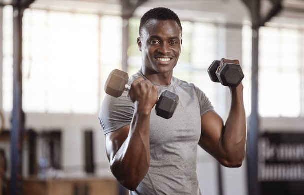 Exercise, dumbbells and portrait of a black man at gym for fitness, training workout and strong muscle. African athlete or bodybuilder person with weights for bicep power and performance at a club. - Foto, Imagen