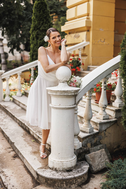 Amazing bride in beautiful white wedding dress posing outdoor while enjoying her wedding day.  - Fotografie, Obrázek