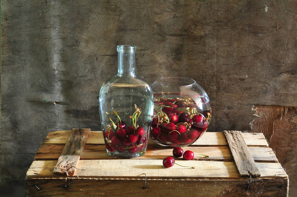 still life with cherries and a bottle of milk in vintage style  - Foto, Imagen