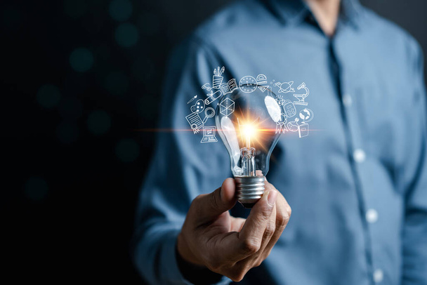 Businessman hand holding light bulb working Creativity, Creative for new idea and innovation with energy and power, growth and success development. - Fotoğraf, Görsel