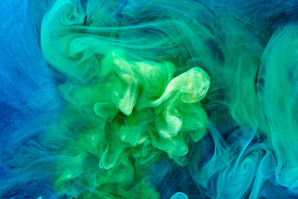 Green blue color abstract smoke background. Mix alcohol ink, creative liquid art mock-up with copy space. Acrylic paint waves underwater - Фото, изображение