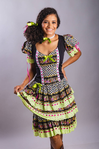 Black Brazilian woman wearing festa junina clothes. Fellowship of Saint John. Arraial, Vertical portrait. - Φωτογραφία, εικόνα
