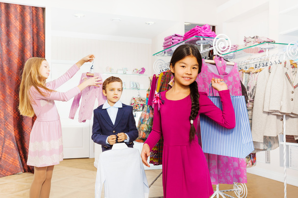 Children standing in clothing store - 写真・画像