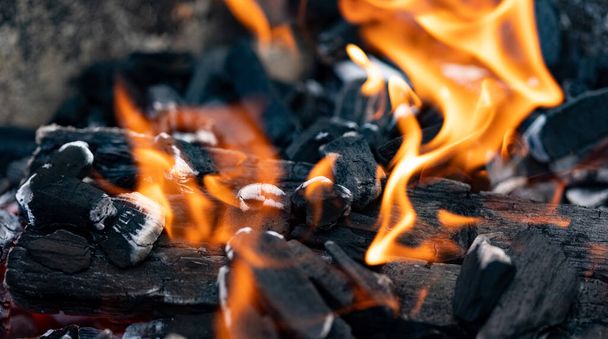 Fire, ember of charcoal on a grill. Close-up of glowing charcoal and hot embers. Barbeque time during summer. Heat, temperature, barbecue time. - Zdjęcie, obraz