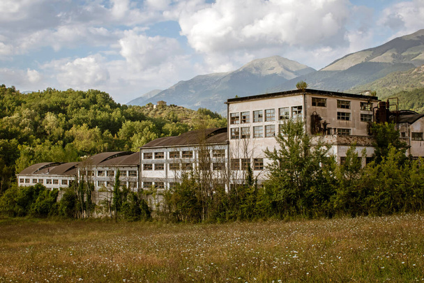 заброшенный химический завод на фоне итальянских гор Апеннин на юго-востоке региона Лацио - Фото, изображение