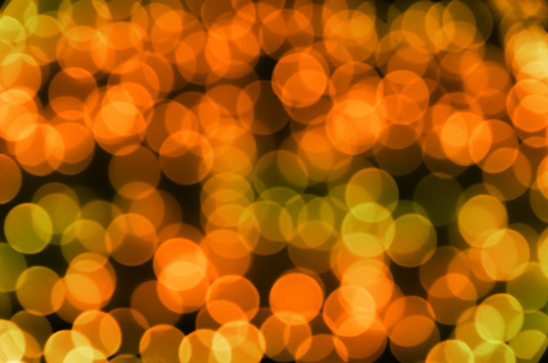 Ünnepi színes izzó absztrakt kerek bokeh narancssárga zöld háttér - Fotó, kép