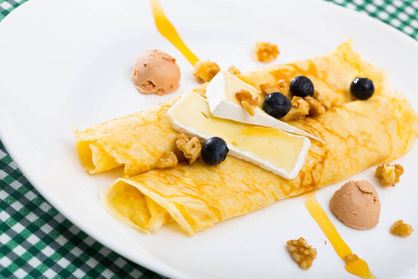 Pancakes with brie cheese, ice cream, fresh blackberries and walnuts - Фото, изображение