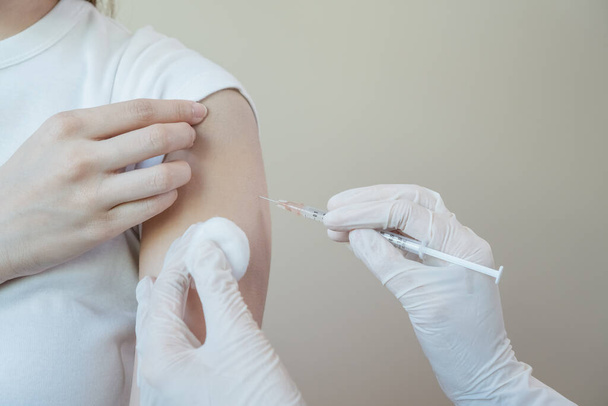 Close up syringe, injection to shoulder. doctor prevent infection, getting vaccine, giving vaccine flu or influenza. Making vaccination protection patient. - 写真・画像