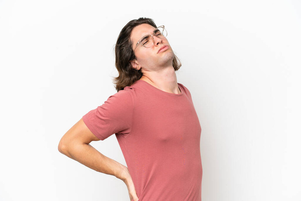 Young handsome man isolated on white background suffering from backache for having made an effort - Φωτογραφία, εικόνα