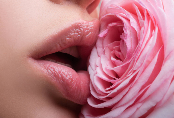 Healthy beautiful young woman with pink lips. Beautiful woman lips with rose - 写真・画像
