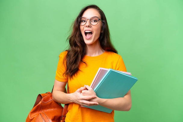 Young student caucasian woman over isolated background with surprise facial expression - Photo, Image