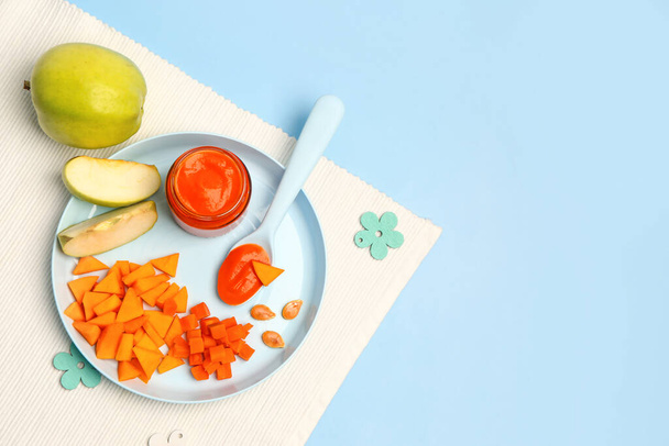 Plate with fresh apple, vegetables and jar of baby food on color background - Photo, Image