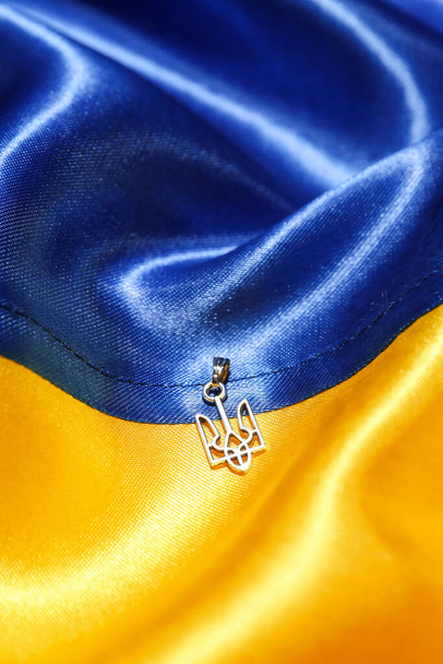 Pendant with Ukrainian coat of arms on flag - Photo, image