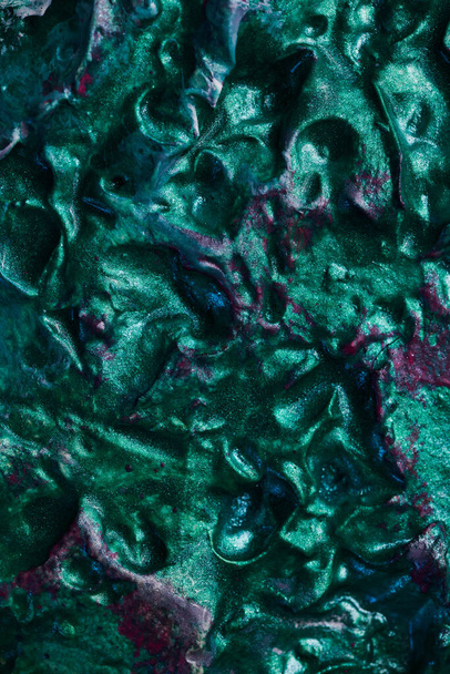 Decorative green putty background. Wall texture with filler paste applied with spatula, chaotic dashes and strokes over plaster. Creative design, stone pattern, cemen - Foto, immagini