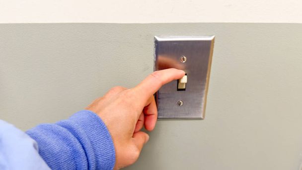 Light switch on and off symbolize control, illumination, and the power to change. They represent the ability to create or remove light, metaphorically representing decision-making and transformation - Photo, Image