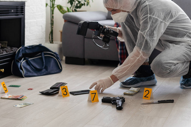 Criminological expert collecting evidence at the crime scene. High quality photo - Photo, Image