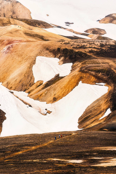Group of hiker hiking on volcanic mountain in summer among Icelandic Highlands at Landmannalaugar, Iceland - Photo, Image