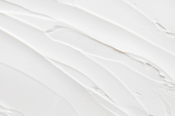 Swatch of white cream texture, cosmetics for face and body on a isolated light grey background. Smear. - Photo, Image