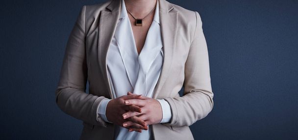 Youve gotta dress your best. Studio shot of an unrecognizable corporate businesswoman posing against a dark background - Fotó, kép