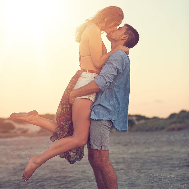 Ein toller Kuss verdient einen anderen. ein liebevolles junges Paar am Strand - Foto, Bild