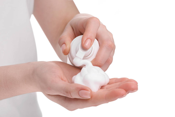 Woman applying cleansing foam onto hand on white background, closeup - Photo, image
