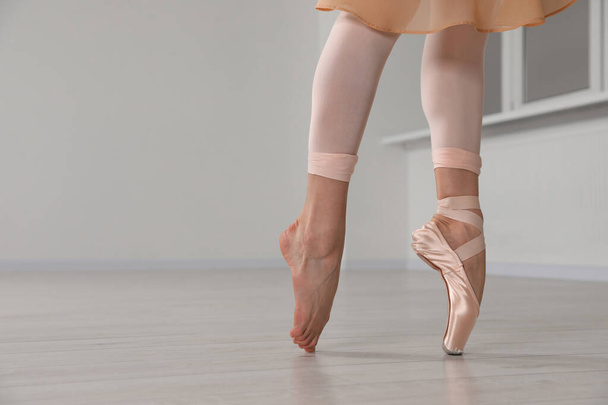 Ballerina in pointe shoe dancing indoors, closeup. Space for text - Photo, image