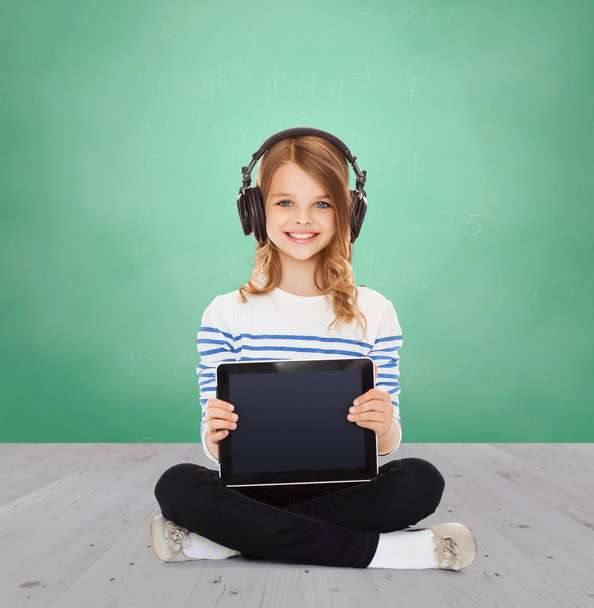 happy girl with headphones showing tablet pc - Фото, зображення