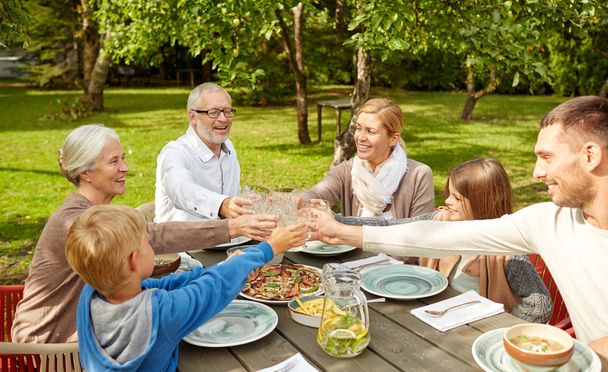 happy family having dinner in summer garden - Fotó, kép