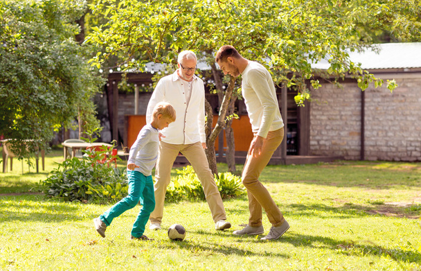 happy family playing football outdoors - Foto, Imagen