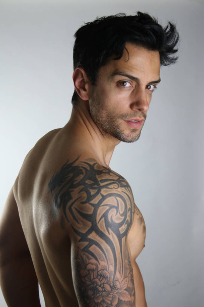 Male shirtless model with perfect body posing over white background. Close-up. Studio shot. - Valokuva, kuva