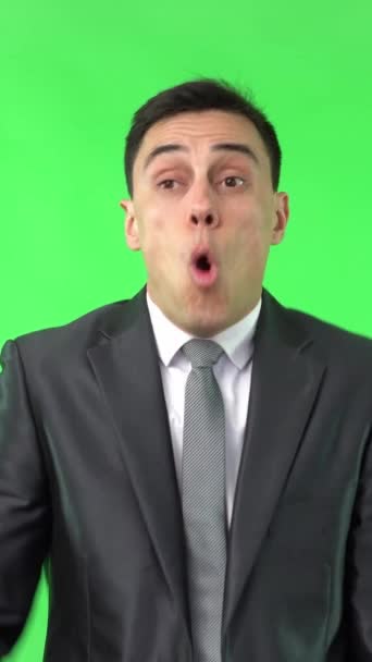 Astonished male in formal outfit touching forehead and looking at camera with opened mouth isolated on chroma key - Footage, Video