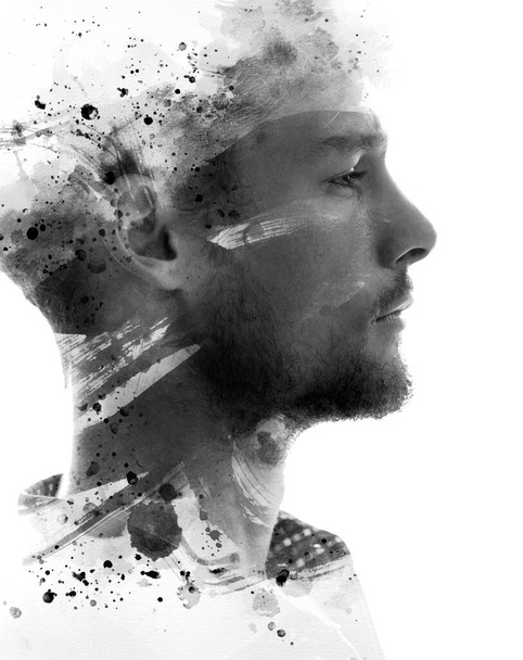 A concept black and white paintography portrait of a bearded mans profile combined with paint stains and brush strokes on white background - Foto, afbeelding
