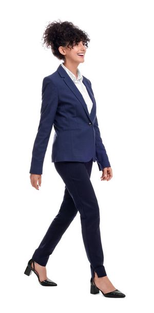 Beautiful businesswoman in suit walking on white background - Photo, image