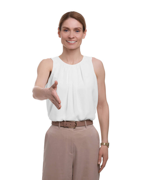 Beautiful happy businesswoman giving handshake on white background - Photo, Image