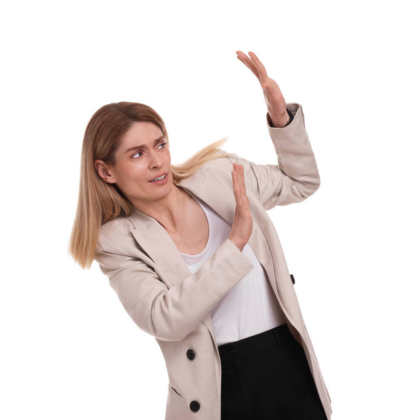 Scared businesswoman avoiding something on white background - Foto, Bild