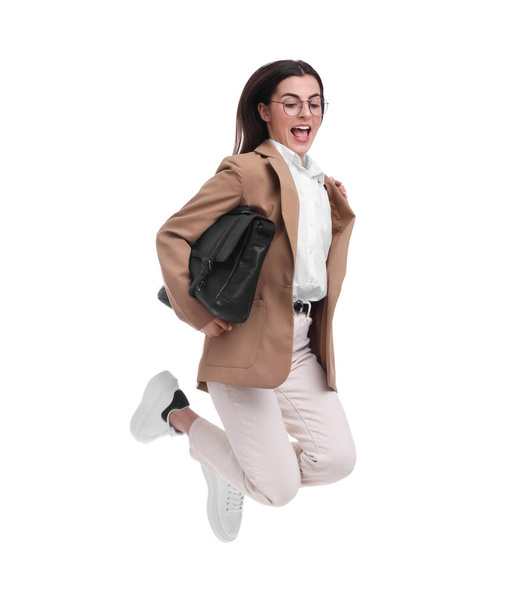 Beautiful businesswoman with briefcase jumping on white background - Фото, зображення