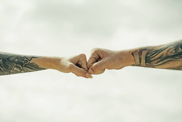 Couple hands with tattoo. Helping hand. Holding hand, close up. Giving a help hand. Rescue, helping gesture or hands. Salvation relations. Help gesture or hands. Support hand - Photo, Image