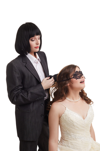 Gay marriage. Groom tied mask over brides eyes - Fotoğraf, Görsel